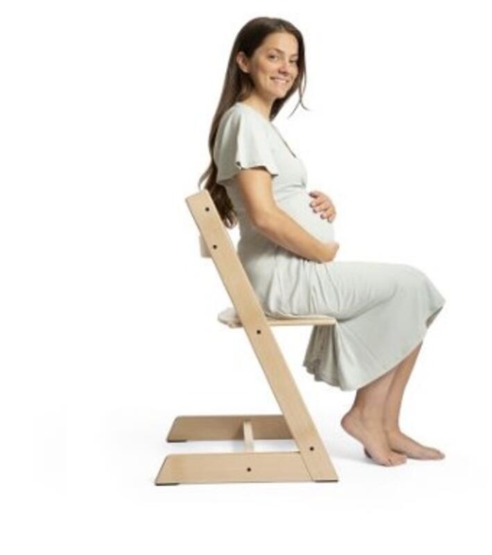 woman sitting on tripp trapp chair