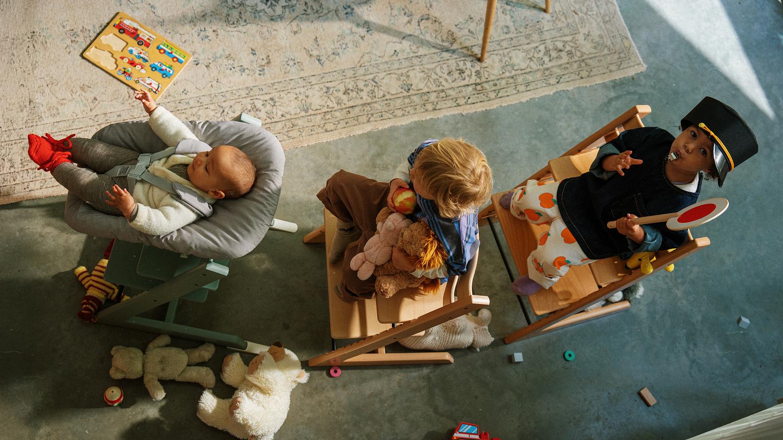 Children playing with Tripp Trapp chairs as a train