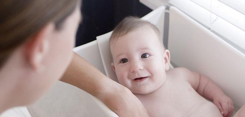 Baby having bath with the father