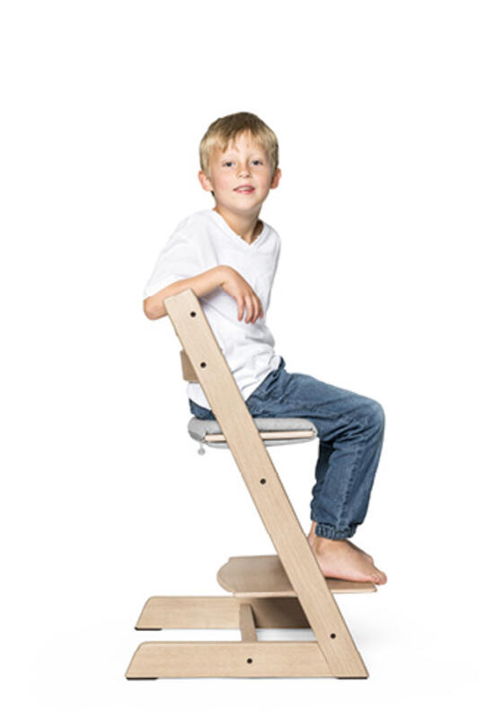 Kid sitting on tripp trapp chair