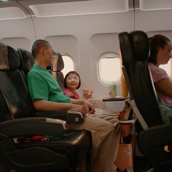 Father and daughter sitting in a plane.