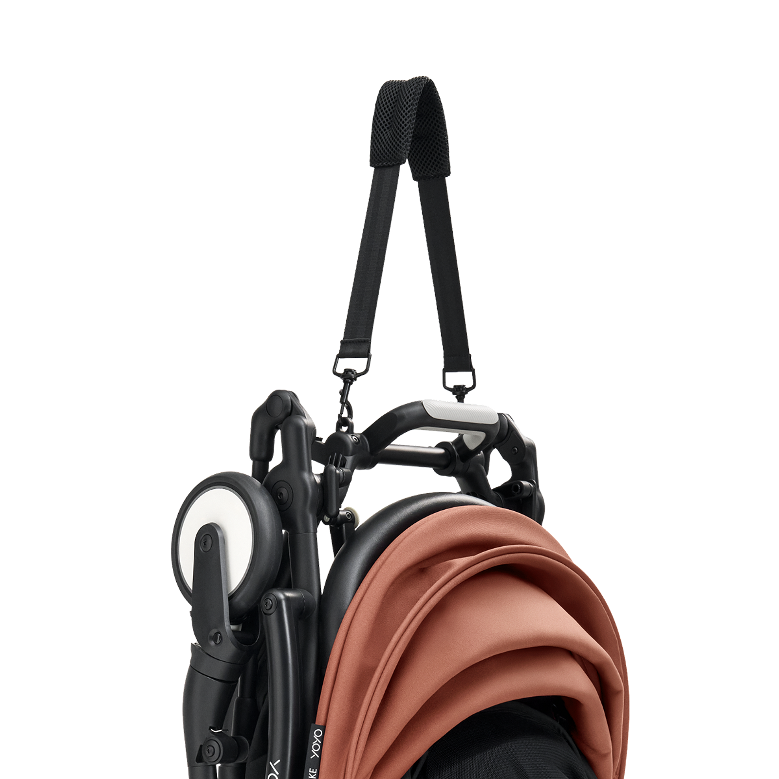 Folded STOKKE YOYO stroller with a burnt orange canopy and black shoulder strap.