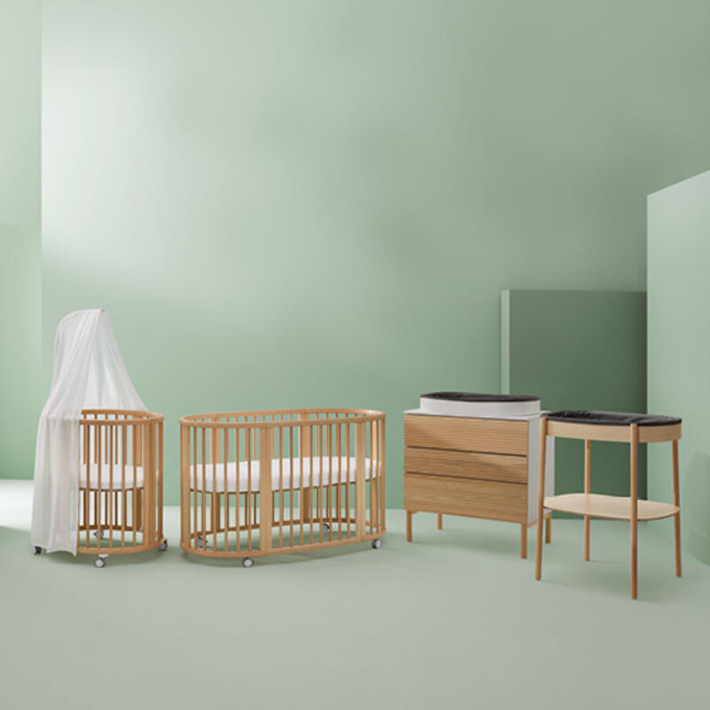 Stokke nursery product including Sleepi bed, Sleepi mini, changing table, and dresser.