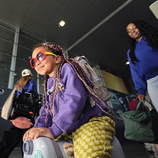 Kid at the airport with JetKids™ travel bundle