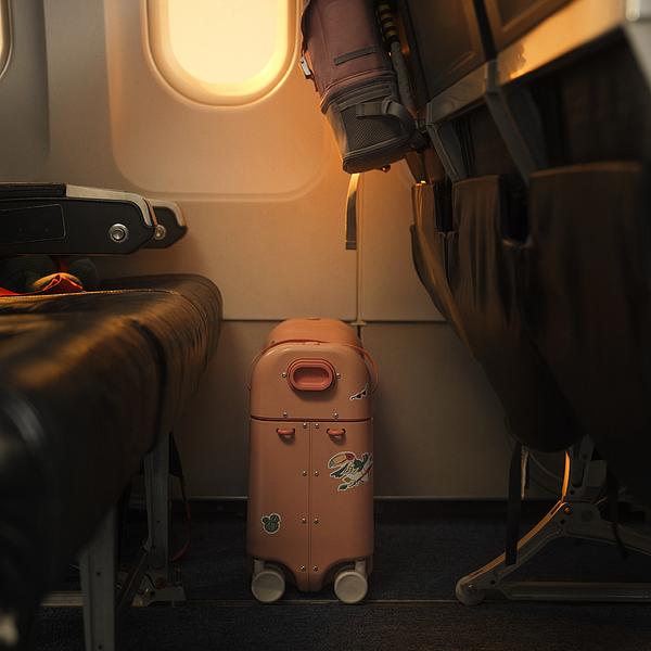 A family is boarding a plane with children who are riding on their JetKids luggage.​