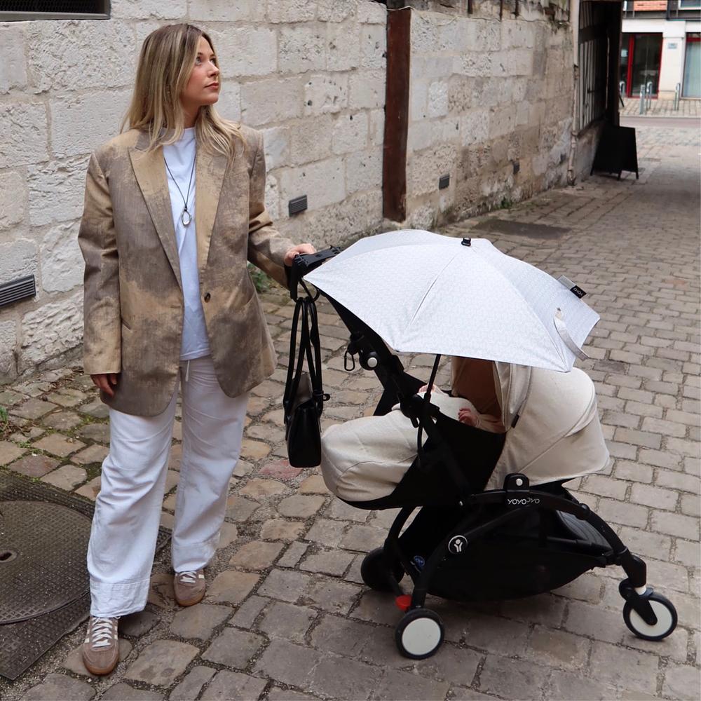 Mom traveling with her newborn in the YOYO Bonpoint stroller.