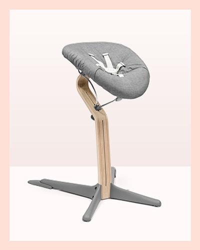 A nomi chair in color grey natural with a grey newborn set. Add to your baby registry checklist.