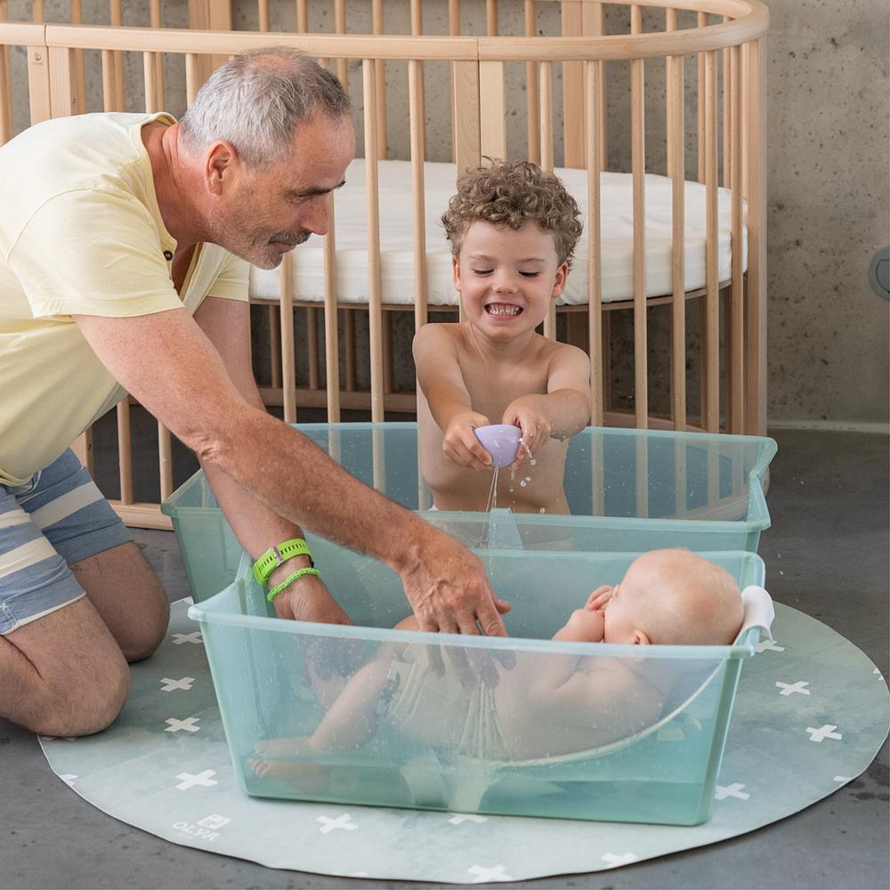 Grandfather bathing his two grandchildren.