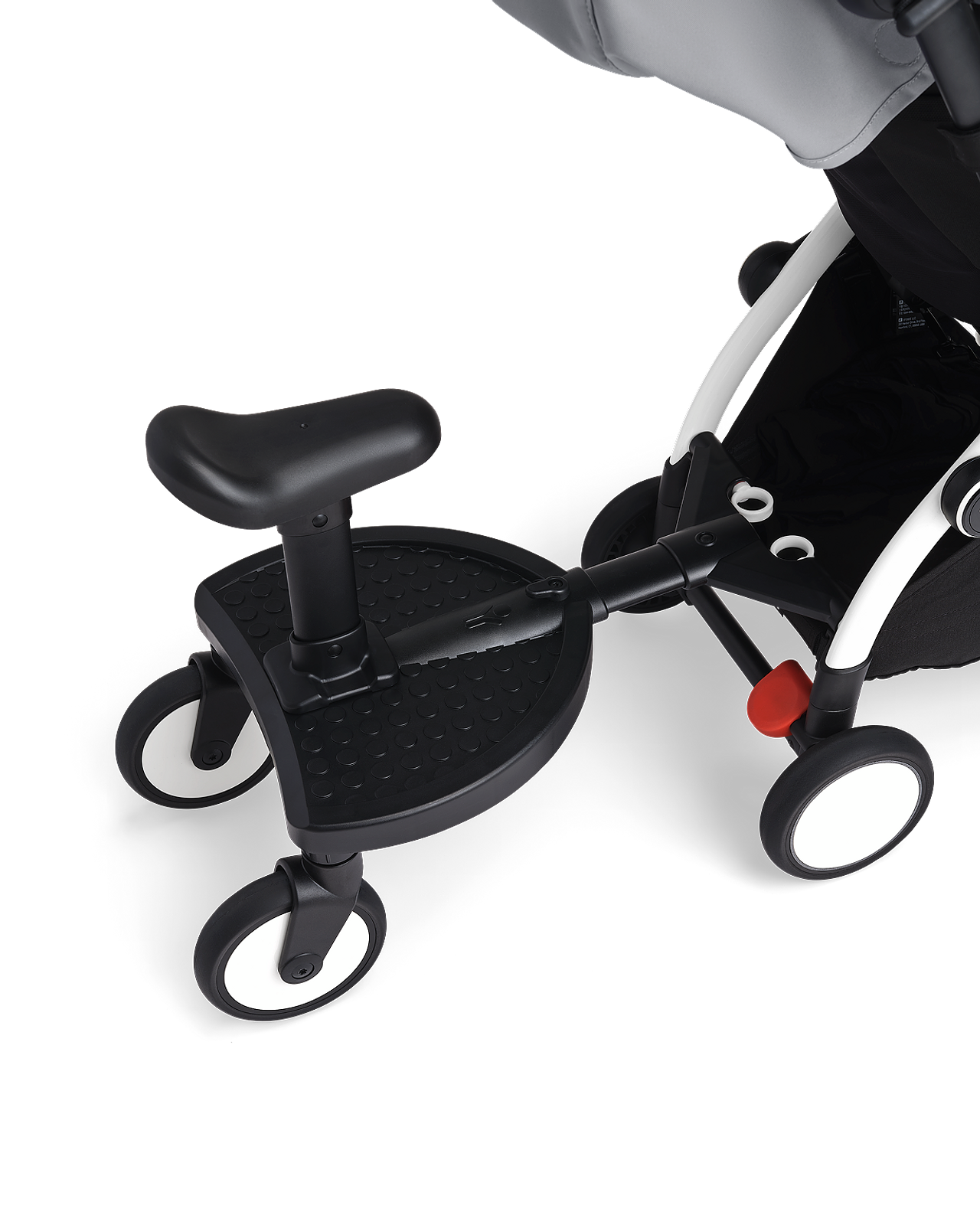 STOKKE YOYO stroller with a black rider board and seat attachment.