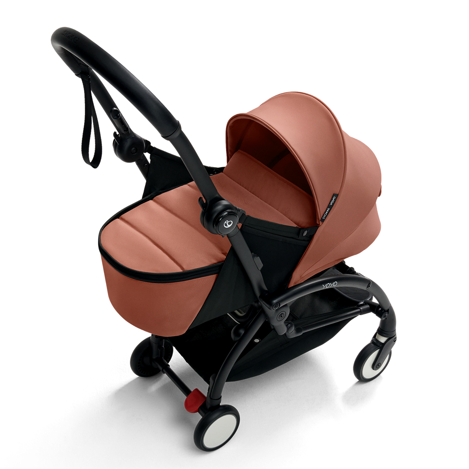 STOKKE YOYO stroller with rust-colored fabrics for newborns on a white background.