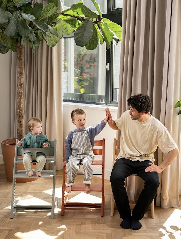Dad with two kids in Tripp Trapp chairs