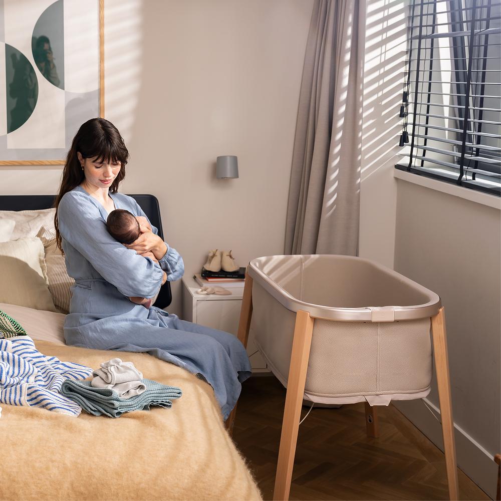 Mom breastfeeding her baby in her bedroom.
