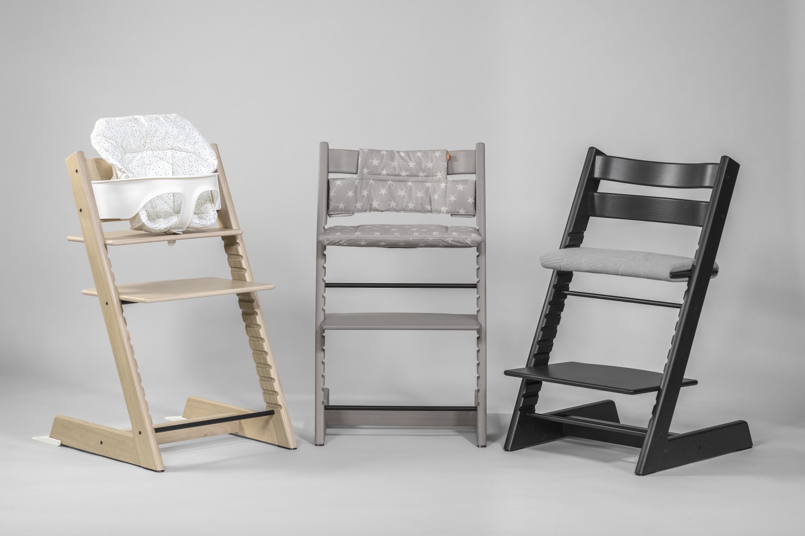 Tripp TrappÂ® chair, Oak Black, Greywash and White, with White Baby Set and Soft Sprinkle Cushion.