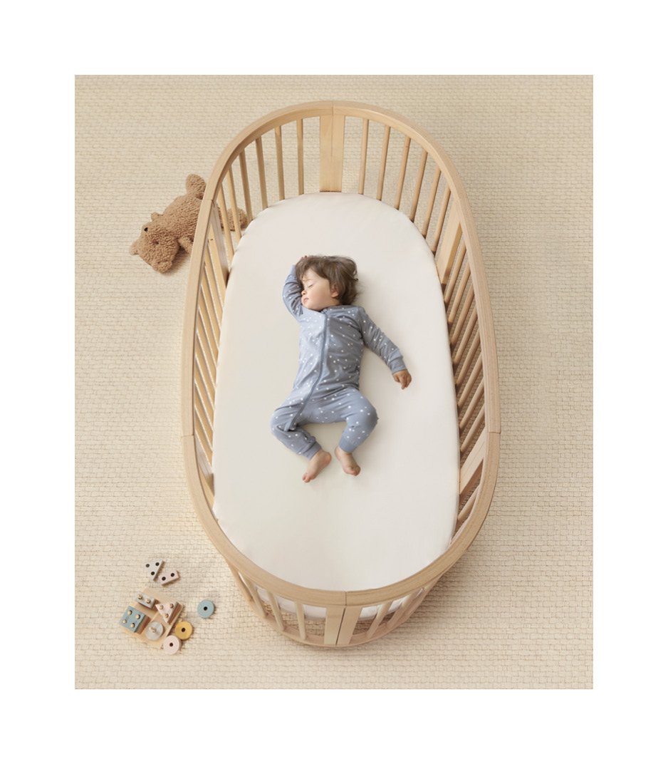 Oval white mattress with dotted brown pattern