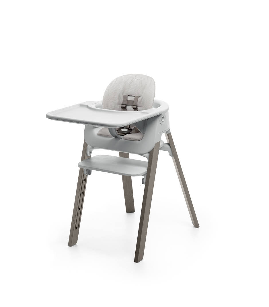 Stokke&reg; Steps&trade; Hazy Grey with Accessories. Baby Set Light Grey. Baby Set Cushion Timeless Grey. Baby Set Tray Light Grey.