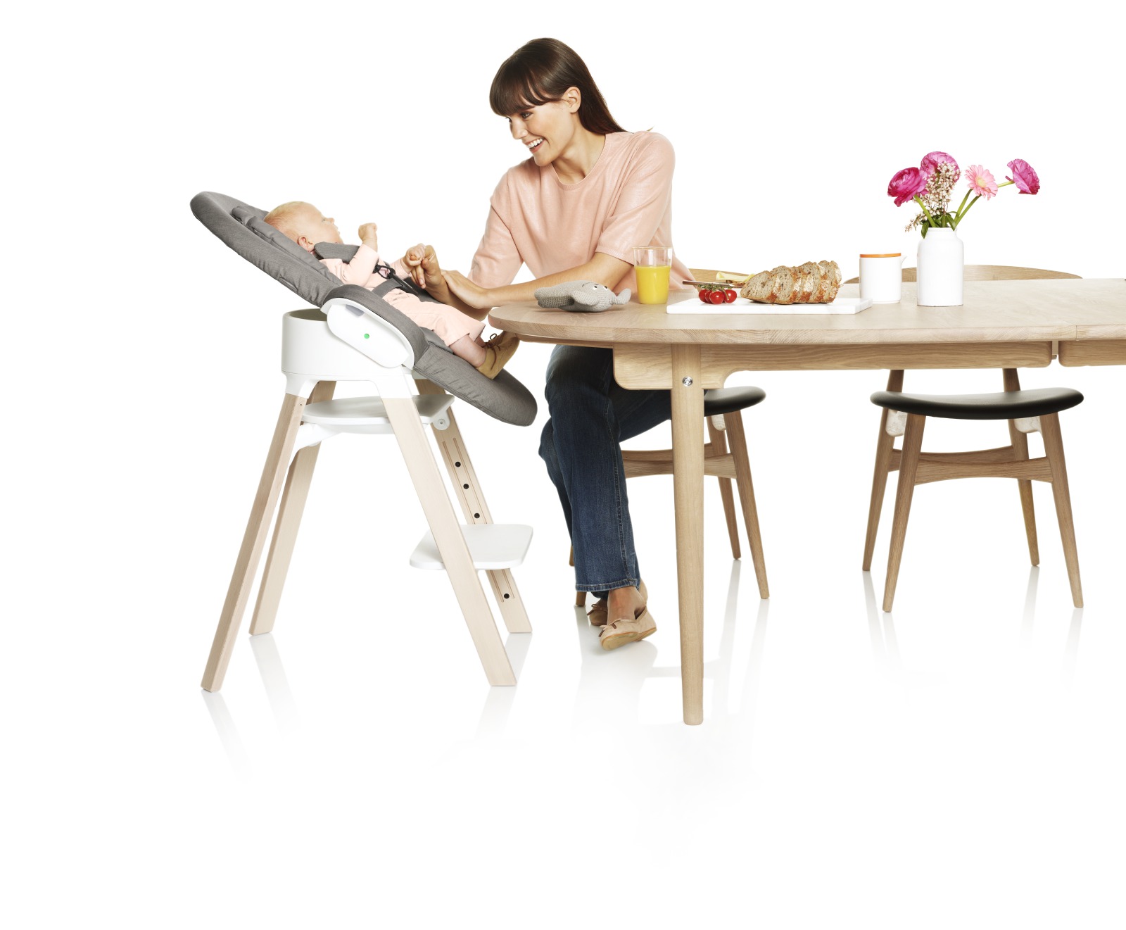 Stokke® Steps™ chair, Beech Natural, with Stokke® Steps™ Newborn Set attached. Greige Textiles.