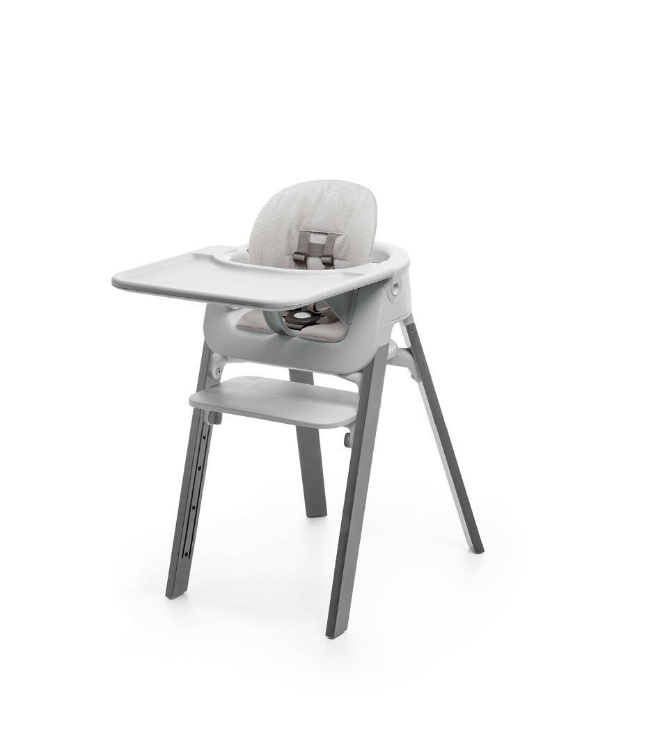 Stokke&reg; Steps&trade; Storm Grey with Accessories. Baby Set Light Grey. Baby Set Cushion Timeless Grey. Baby Set Tray Light Grey.