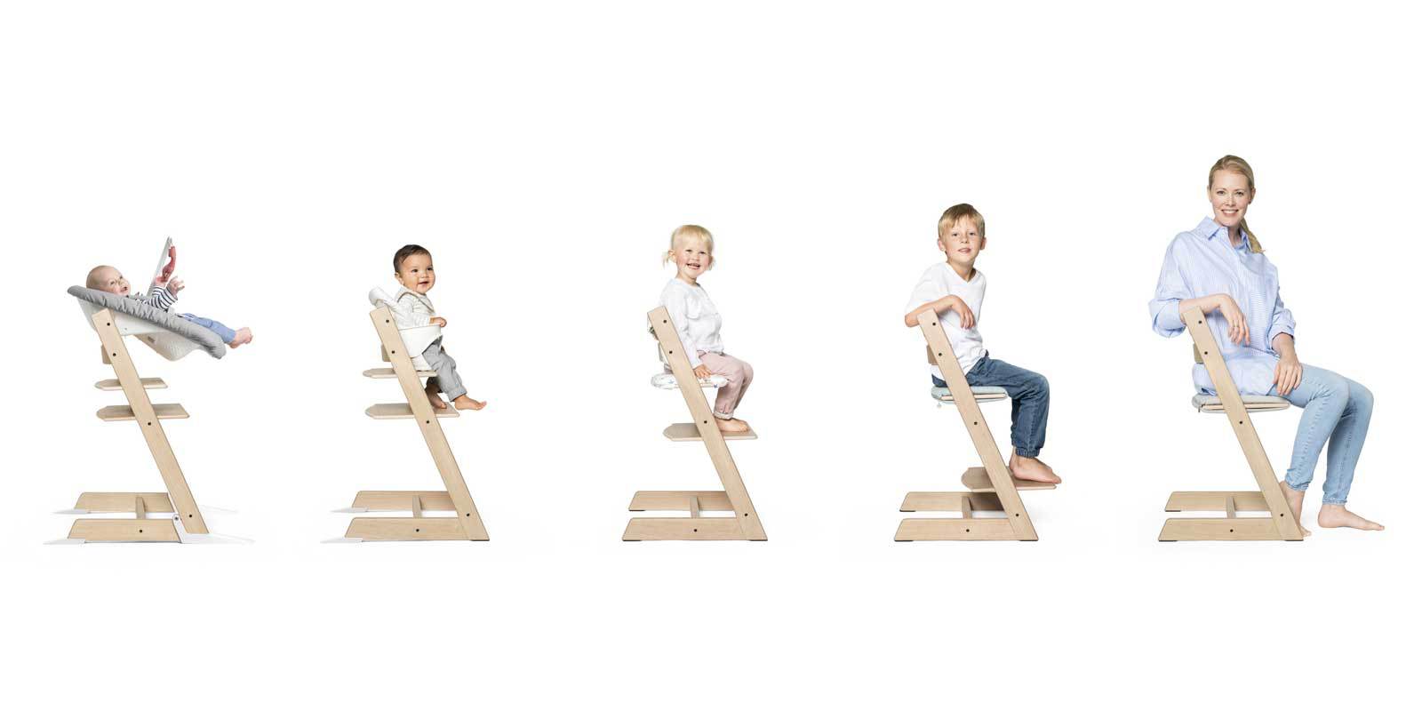 Five cream Stokke Tripp Trapp High Chairs , each seating either a baby, a child, or an adult. Set against a white background.