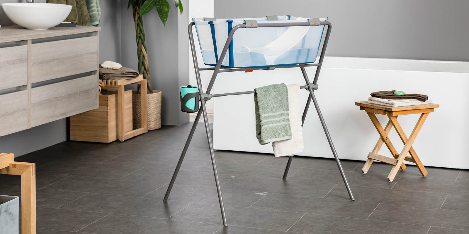 Stokke® Flexi Bath® Transparent Blue with Newborn Support, on Stokke™ Flexi Bath™ Stand. Stokke® Flexi Bath® Transparent Blue with Newborn Support, on Stokke™ Flexi Bath™ Stand.