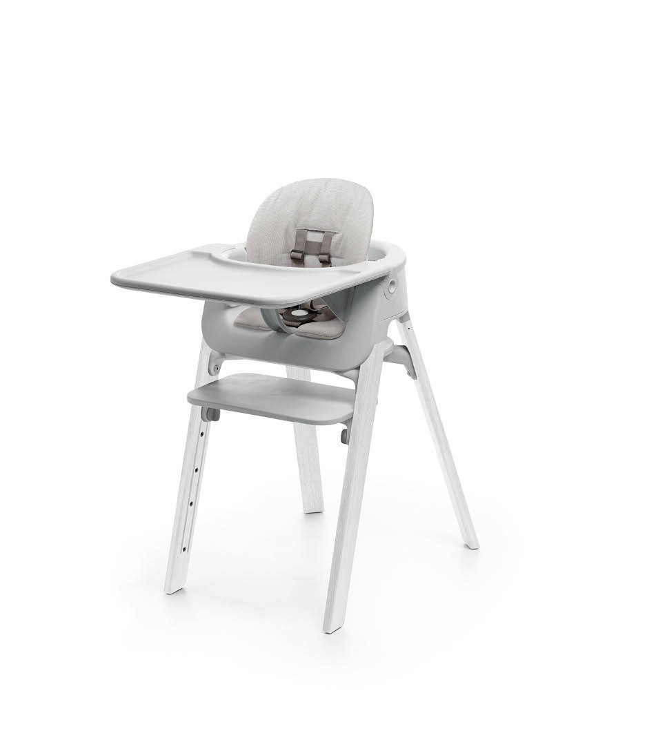 Stokke&reg; Steps&trade; Oak White with Accessories. Baby Set Light Grey. Baby Set Cushion Timeless Grey. Baby Set Tray Light Grey.